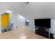 A living space with light blue walls, wood flooring, and a television at 624 Powhatan Dr, Fuquay Varina, NC 27526