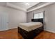Bedroom with tray ceiling, hardwood floors, and natural light at 624 Powhatan Dr, Fuquay Varina, NC 27526
