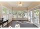 Inviting sunroom with tile floor, multiple windows, and backyard access at 624 Powhatan Dr, Fuquay Varina, NC 27526