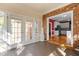 Sunroom featuring brick walls and views into the kitchen at 624 Powhatan Dr, Fuquay Varina, NC 27526