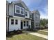Charming new two-story home with a well-manicured lawn and sidewalk leading to the front door at 6449 Granite Quarry Dr, Raleigh, NC 27610