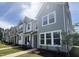 Row of new construction townhomes with varied siding, landscaping, and sidewalks at 6451 Granite Quarry Dr, Raleigh, NC 27610