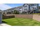 Spacious backyard with a retaining wall and view of neighboring homes at 6624 Vestal St, Wake Forest, NC 27587