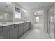 Bright bathroom featuring double vanity, tile floors, and access to shower and bedroom at 6624 Vestal St, Wake Forest, NC 27587