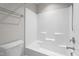 Bright bathroom featuring tub/shower combo with sleek fixtures and a tiled surround at 6624 Vestal St, Wake Forest, NC 27587