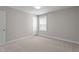 Standard bedroom with carpet flooring, window with blinds, and gray walls at 6624 Vestal St, Wake Forest, NC 27587