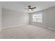 Bedroom with neutral carpet, ceiling fan, and a large window offering ample natural light at 6624 Vestal St, Wake Forest, NC 27587