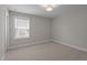 Standard bedroom with carpet flooring, window with blinds, and gray walls at 6624 Vestal St, Wake Forest, NC 27587