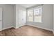 Bedroom features a closet and window, offering a simple and functional space with wood-look floors at 6624 Vestal St, Wake Forest, NC 27587