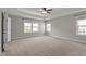 Bright and airy bedroom with tray ceiling and two large windows, carpet throughout at 6624 Vestal St, Wake Forest, NC 27587