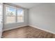 Bedroom with a large window providing natural light, complemented by neutral walls and wood flooring at 6624 Vestal St, Wake Forest, NC 27587