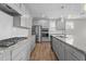 A kitchen featuring stainless steel appliances, gray cabinets, granite countertops, and a large island at 6624 Vestal St, Wake Forest, NC 27587