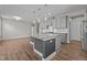 Kitchen view highlighting gray cabinets, granite countertops, pendant lighting, and stainless steel appliances at 6624 Vestal St, Wake Forest, NC 27587