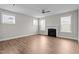 A spacious living room featuring a fireplace, ceiling fan, and plenty of natural light from large windows at 6624 Vestal St, Wake Forest, NC 27587