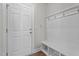 Mudroom features coat hooks, a bench with storage, and a door, providing a practical entry point at 6624 Vestal St, Wake Forest, NC 27587