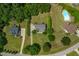 Aerial view of home showcasing lush landscaping, backyard pool, and neighborhood at 8140 Consella Way, Willow Springs, NC 27592