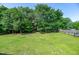 Well-maintained backyard surrounded by mature trees and lush green lawn at 8140 Consella Way, Willow Springs, NC 27592