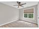 Bedroom with a fan, a neutral colored wall, carpet, baseboard and a large window at 8140 Consella Way, Willow Springs, NC 27592
