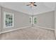 Spacious bedroom with plush carpet, vaulted ceiling and plenty of natural light from large windows at 8140 Consella Way, Willow Springs, NC 27592