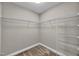 Walk-in closet with carpeted floor and shelving for ample storage in this home at 8140 Consella Way, Willow Springs, NC 27592