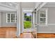 Bright foyer with gleaming hardwood floors, transom windows, and an inviting view at 8140 Consella Way, Willow Springs, NC 27592