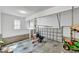 Well-lit garage interior with storage shelving and equipment like a lawn mower and wheelbarrow at 8140 Consella Way, Willow Springs, NC 27592