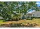 Charming backyard with a cozy deck, garden area, and the home's light siding, creating a serene outdoor living space at 85 Clubhouse Dr, Youngsville, NC 27596