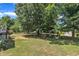 Expansive backyard with lush greenery, mature trees, and a tranquil hammock, offering a private and relaxing outdoor retreat at 85 Clubhouse Dr, Youngsville, NC 27596