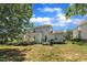 The backyard with a house, deck, patio, and garden area offers multiple spaces for outdoor enjoyment and relaxation at 85 Clubhouse Dr, Youngsville, NC 27596
