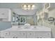 Bright bathroom featuring a double vanity, ample storage, and a large mirror reflecting natural light at 85 Clubhouse Dr, Youngsville, NC 27596