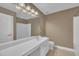 Bathroom with long vanity, large mirror, shower-tub combo, and tile floors at 85 Clubhouse Dr, Youngsville, NC 27596