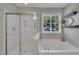 Bright and luxurious bathroom featuring a separate shower, soaking tub, and natural light at 85 Clubhouse Dr, Youngsville, NC 27596