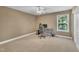 Bedroom with neutral colors, ceiling fan, and a desk with gaming chair at 85 Clubhouse Dr, Youngsville, NC 27596