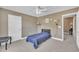 Cozy bedroom with neutral tones, complemented by a single bed, carpet flooring, and ample natural light at 85 Clubhouse Dr, Youngsville, NC 27596