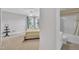 Bedroom with an open doorway to a bathroom, neutral carpet, and a comfy bed at 85 Clubhouse Dr, Youngsville, NC 27596
