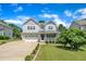 Charming two-story home featuring a manicured lawn, long driveway, and inviting front porch at 85 Clubhouse Dr, Youngsville, NC 27596