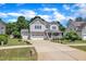 Charming two-story home with a well-manicured lawn and long driveway leading to an attached two-car garage at 85 Clubhouse Dr, Youngsville, NC 27596