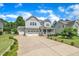Charming two-story home with a well-manicured lawn and long driveway leading to an attached two-car garage at 85 Clubhouse Dr, Youngsville, NC 27596