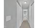 Clean and well-maintained hallway with neutral carpet, providing access to rooms with white doors at 85 Clubhouse Dr, Youngsville, NC 27596