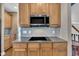 Kitchen featuring electric cooktop, stainless microwave, and ample cabinet space at 85 Clubhouse Dr, Youngsville, NC 27596