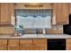 Bright kitchen featuring a double bowl sink, window with light pouring through, and cabinetry offering ample storage space at 85 Clubhouse Dr, Youngsville, NC 27596