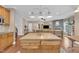 Open kitchen island with view into the expansive living room with fireplace at 85 Clubhouse Dr, Youngsville, NC 27596
