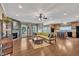 Bright open-concept living room with stone fireplace, hardwood floors and a seamless transition to the modern kitchen at 85 Clubhouse Dr, Youngsville, NC 27596