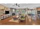 Inviting living room featuring hardwood floors, a stone fireplace, and a seamless connection to the kitchen at 85 Clubhouse Dr, Youngsville, NC 27596