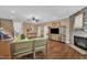 Open-concept living area with hardwood floors, stone fireplace, and seamless flow, creating a welcoming atmosphere at 85 Clubhouse Dr, Youngsville, NC 27596