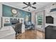 Inviting office space featuring custom built-ins, ceiling fan, and natural light streaming through the window at 85 Clubhouse Dr, Youngsville, NC 27596