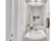 Elegant powder room with a stylish sink and decorative mirror, offering a touch of sophistication at 85 Clubhouse Dr, Youngsville, NC 27596