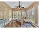 Cozy sunroom with hardwood floors, natural light, and comfortable seating area at 85 Clubhouse Dr, Youngsville, NC 27596