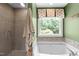 Soaking tub with shower and garden view at 8536 Wolverton Fields Dr, Wake Forest, NC 27587