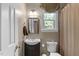 Updated bathroom with dark vanity, neutral walls, and a shower with a patterned curtain at 8536 Wolverton Fields Dr, Wake Forest, NC 27587